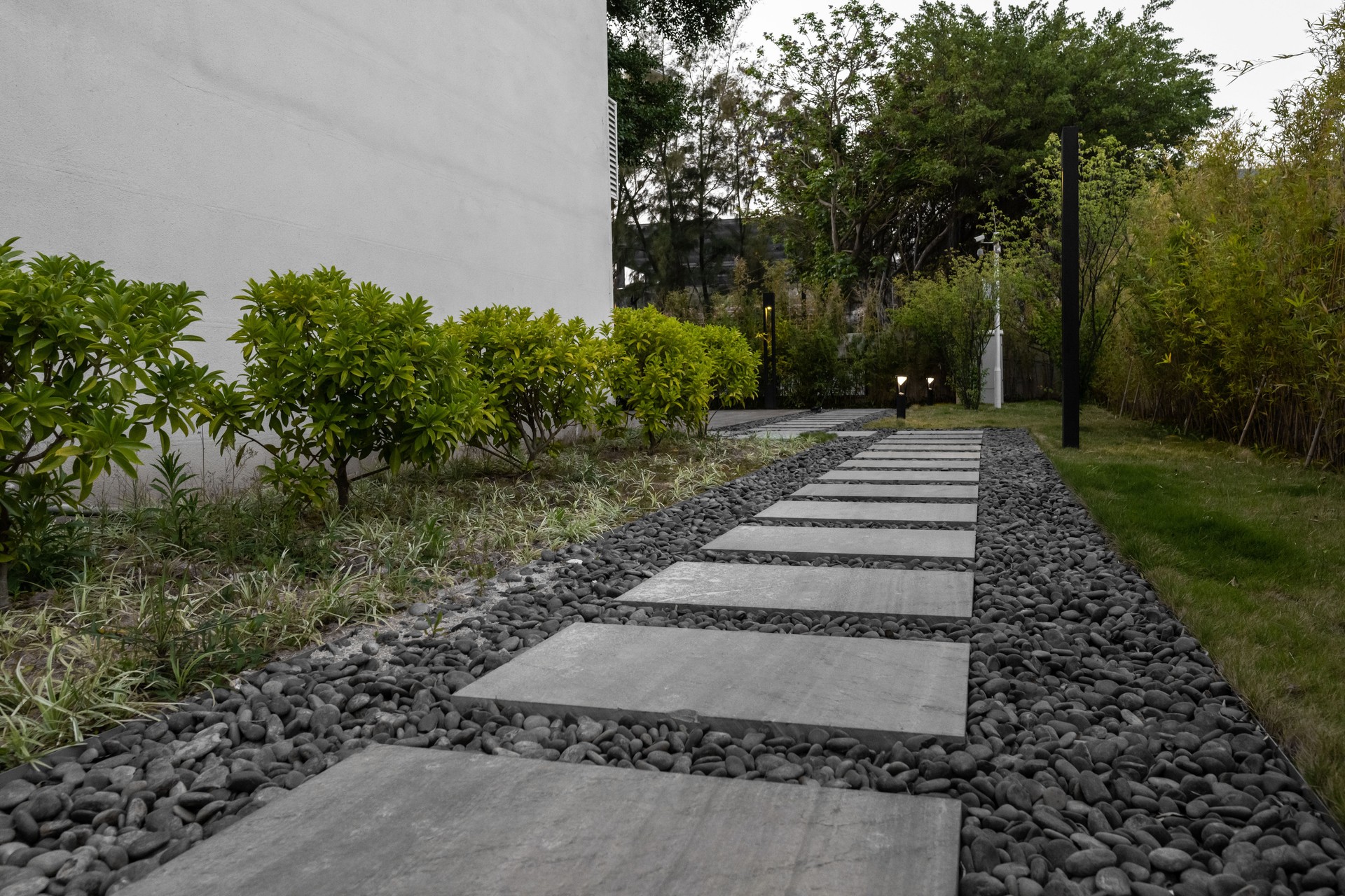 The stone path beside the white building